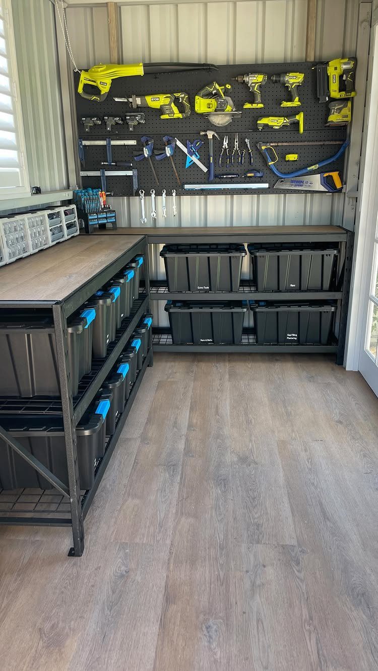9 Shed Yard Tool Storage Ideas for Every Wall and Corner 3 Yellow power tools and hand tools hanging on a black pegboard with hooks in a workshop.