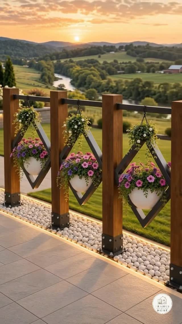 Diamond-shaped wooden frames with hanging white planters filled with colorful flowers on a scenic patio.